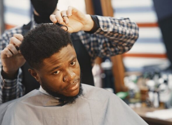 young-african-american-man-visiting-barbershop_1157-47697